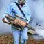 Fumigation technician applying smoke treatment for pest control in {city}, {state}